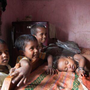 Three boys watching their baby sister sleep.
