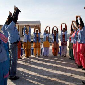 DIR's Health Promoters start the day by doing yoga on the rooftop.