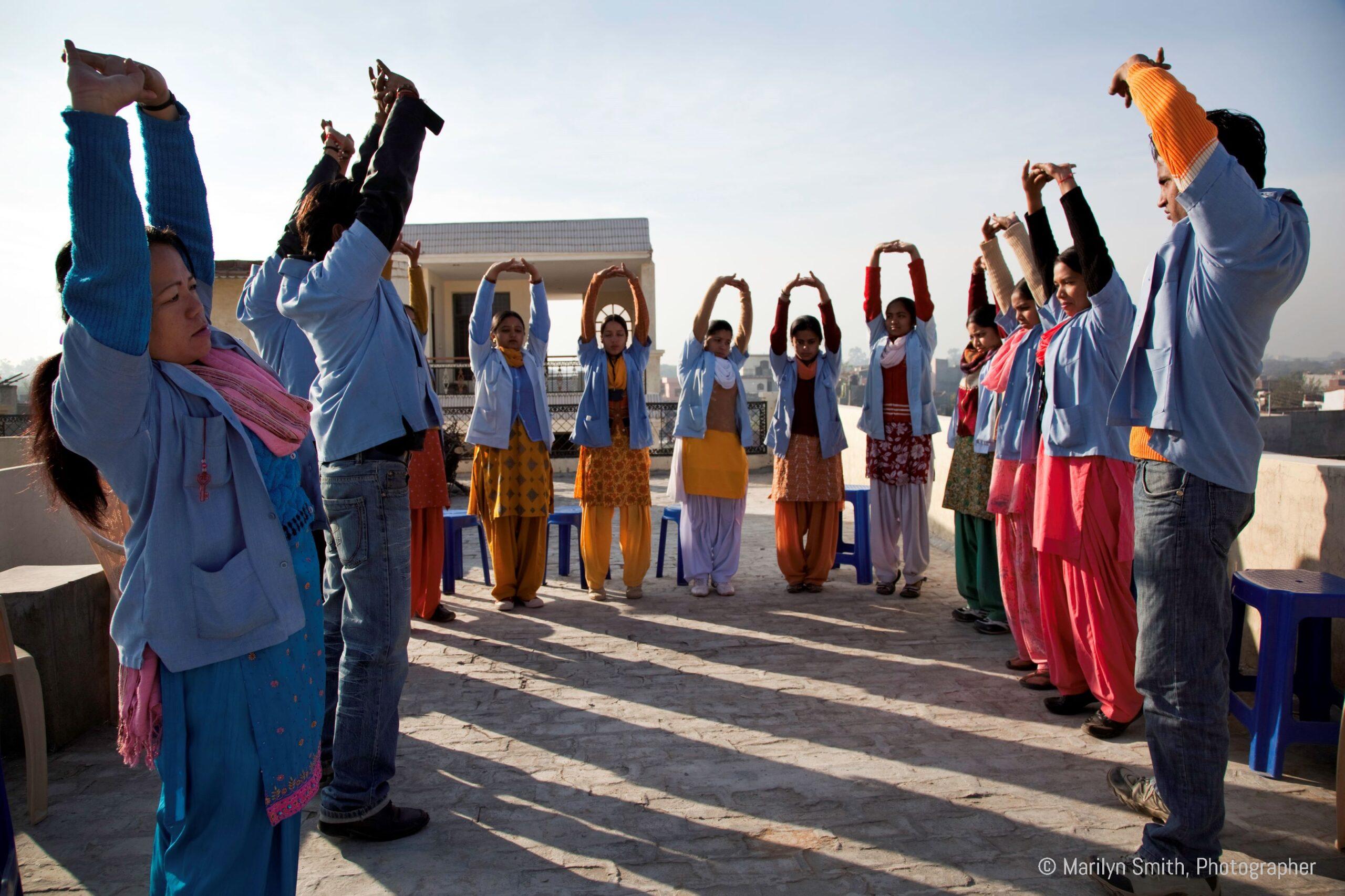 DIR's Health Promoters start the day by doing yoga on the rooftop.