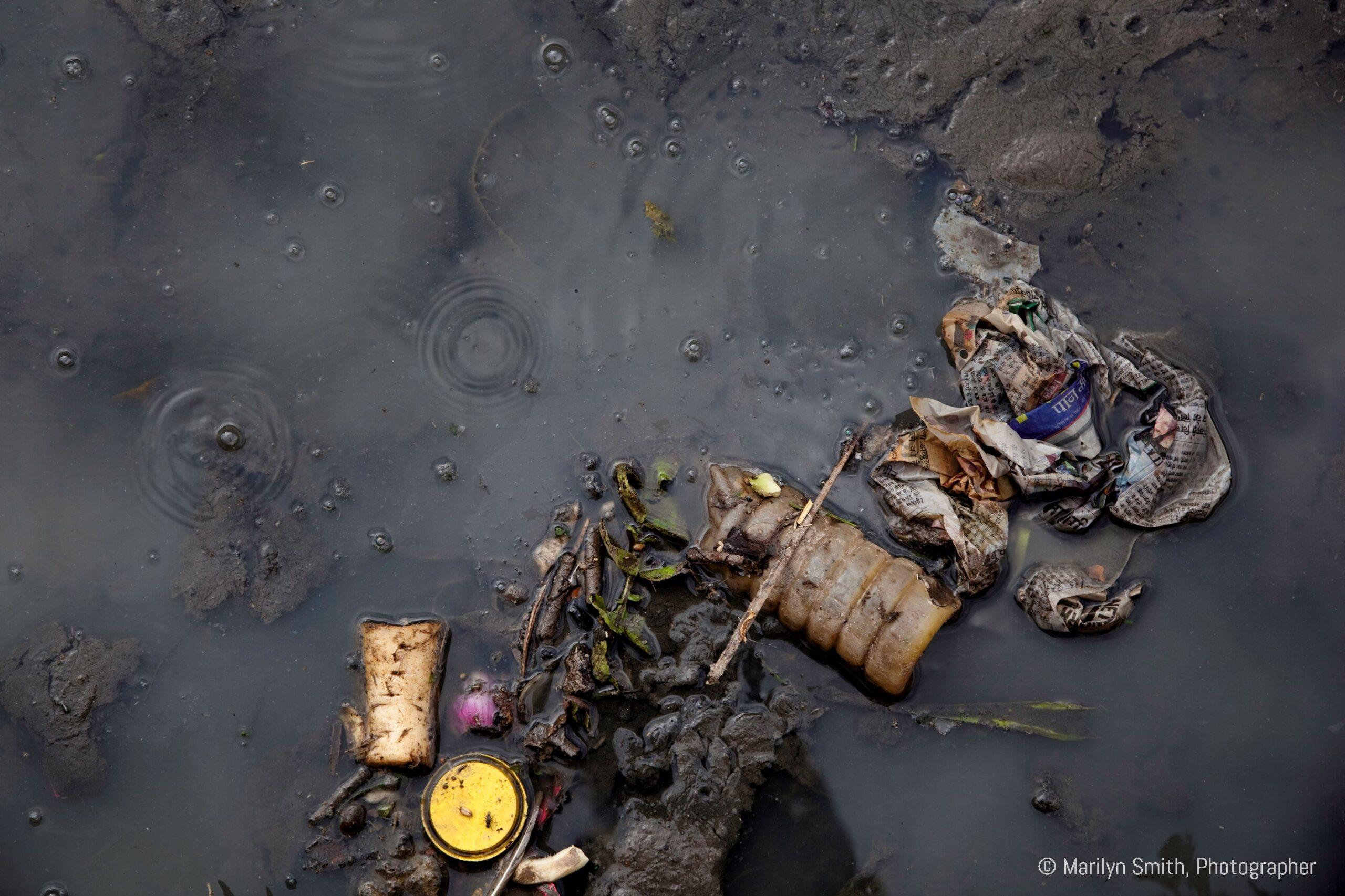 Garbage floating in a swamp in Janta Colony.