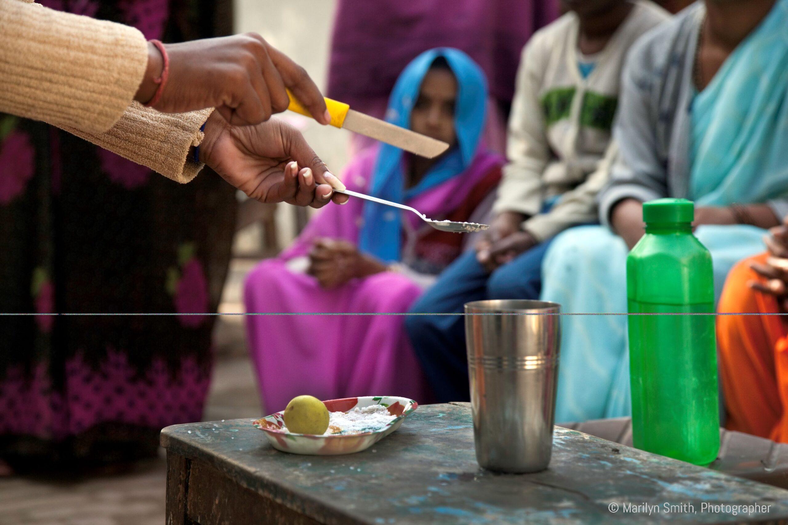 A DIR HP showing mothers how to make an oral rehydration solution.