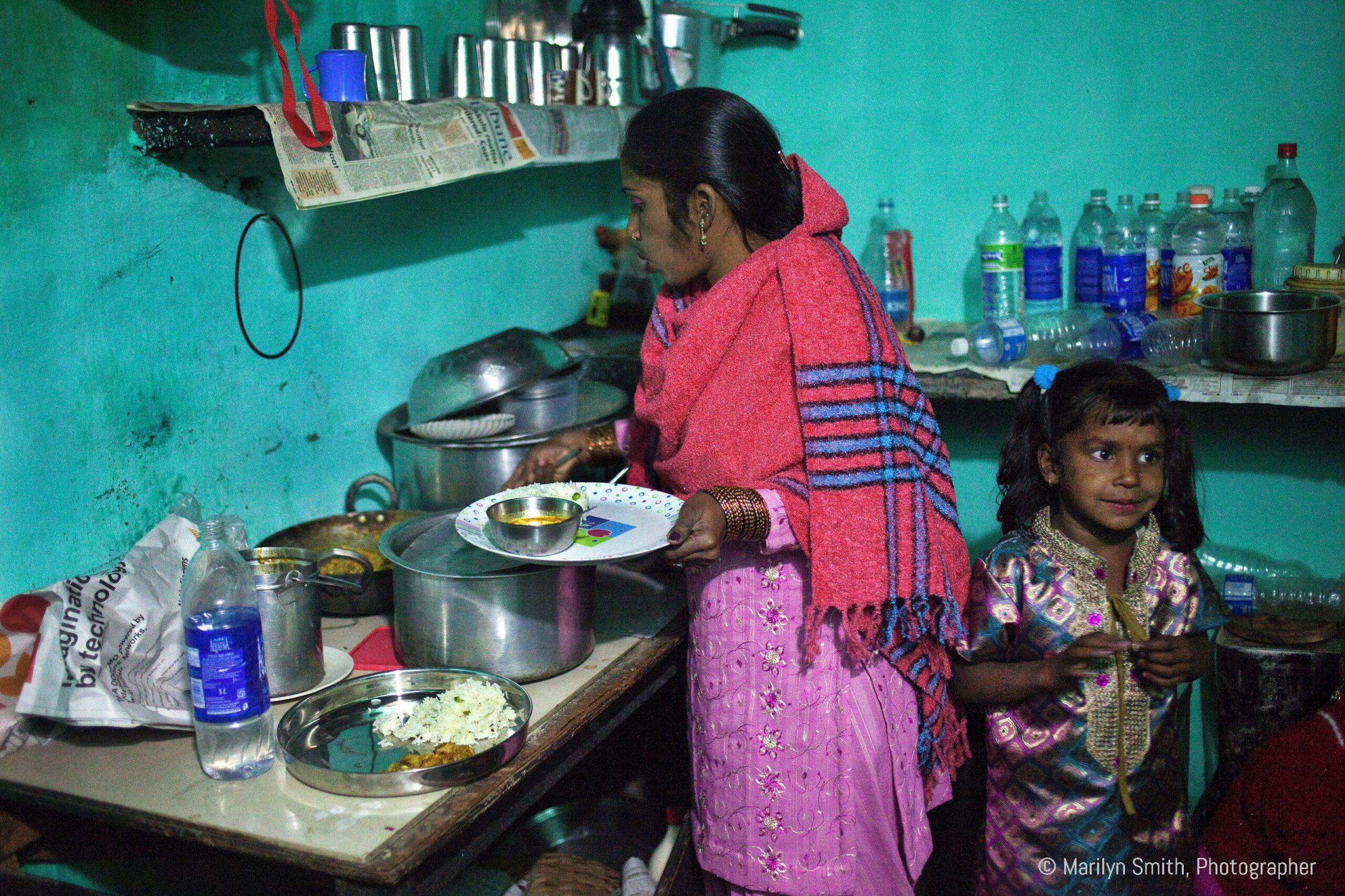 A mother cooks healthy food for her daughter's birthday party.