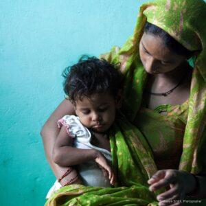 A mother who has taken the advice of DIR HPs holds a healthy baby.