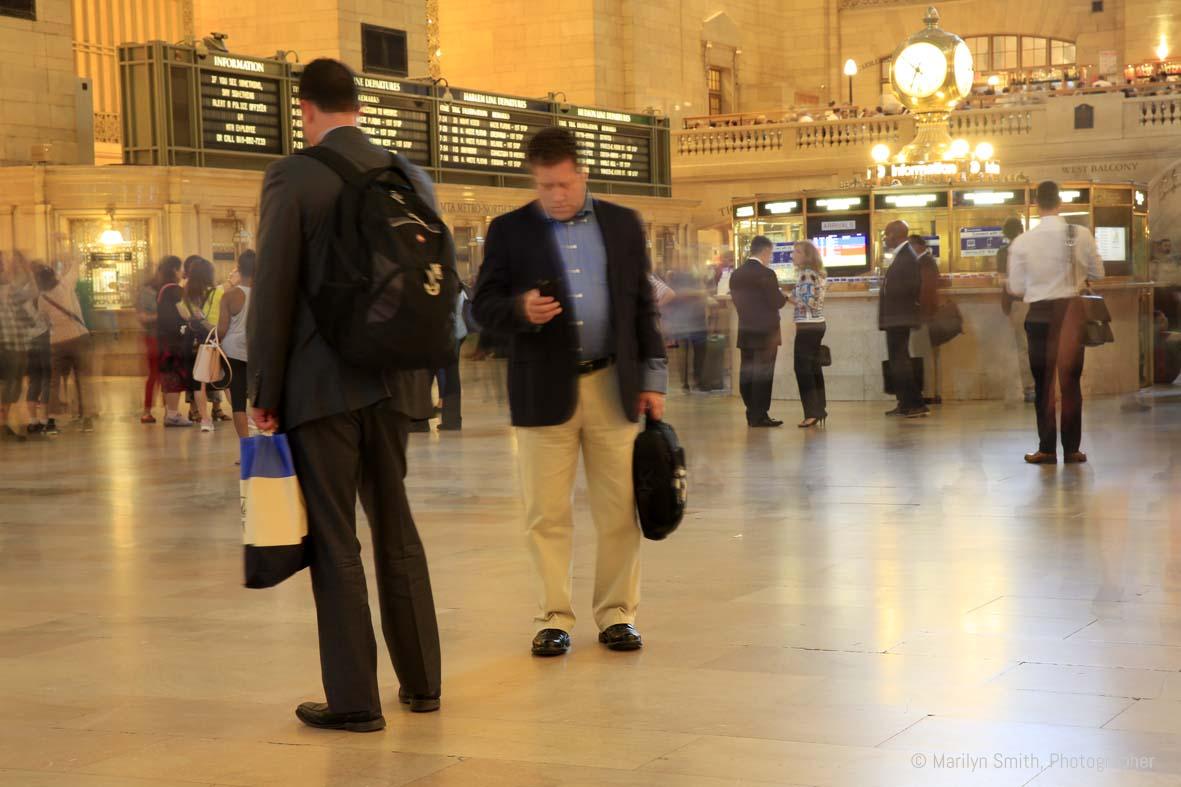 A long exposure during rush hour in Grand Central Station, New York City, gives the impression that only a ew people standing still are actually there.
